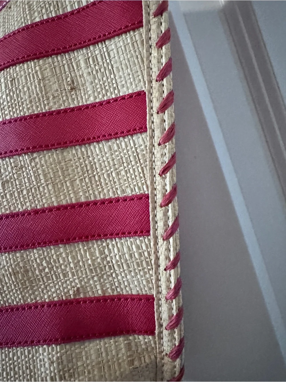 Tory Burch straw tote features vibrant red leather stripes